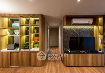 Modern living room with stylish wooden cabinetry and sleek TV setup