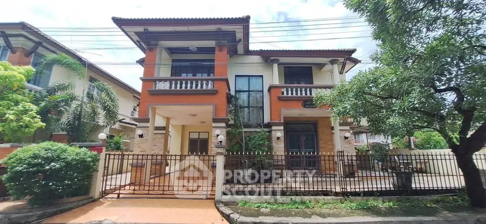 Stunning two-story house with spacious driveway and lush greenery, perfect for family living.