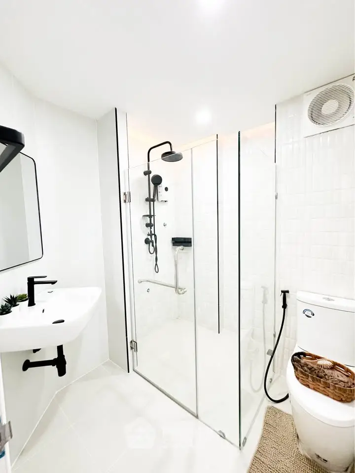 Modern bathroom with glass shower enclosure and sleek fixtures