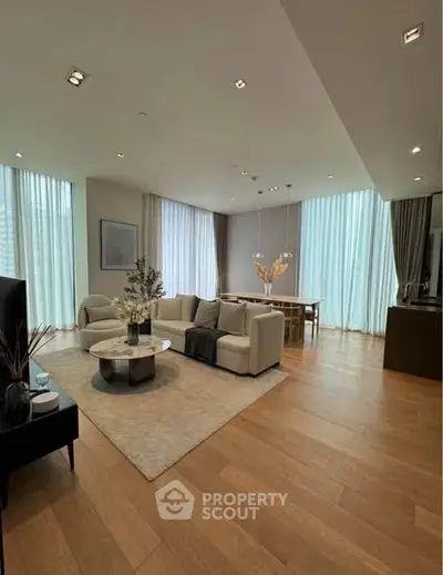 Luxurious modern living room with elegant decor and large windows in a high-end apartment.