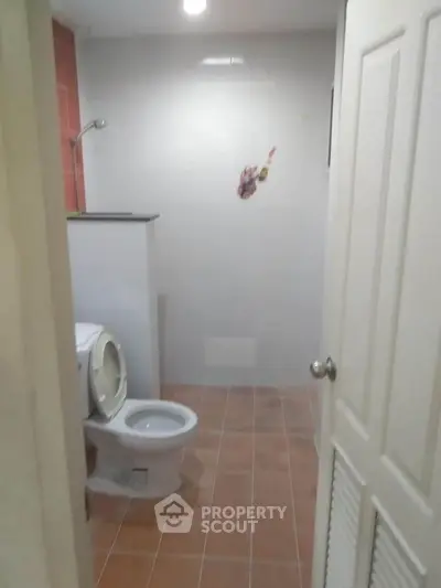 Cozy bathroom with tiled floor and modern fixtures in a real estate property.