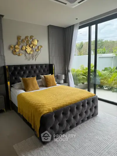 Luxurious bedroom with plush bed and large windows overlooking a lush garden, featuring elegant decor and ample natural light.