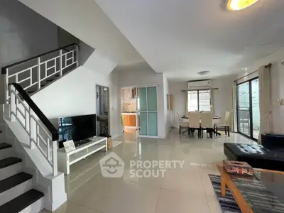 Spacious modern living room with open layout and stylish staircase