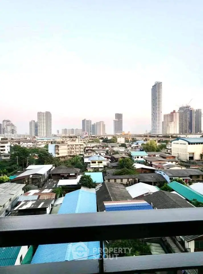Stunning cityscape view from a high-rise balcony showcasing urban skyline and vibrant neighborhood.