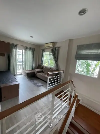 Charming split-level living room with cozy sofa and natural light