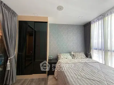 Modern bedroom with stylish decor and large windows for natural light