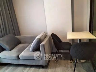 Modern living room with stylish gray sofa and sleek dining table