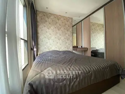 Cozy bedroom with large window and mirrored wardrobe in modern apartment