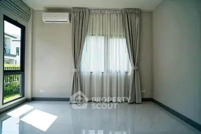 Bright empty room with large windows and elegant curtains, perfect for customization.