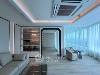 Luxurious modern living room with sleek design and panoramic city views.