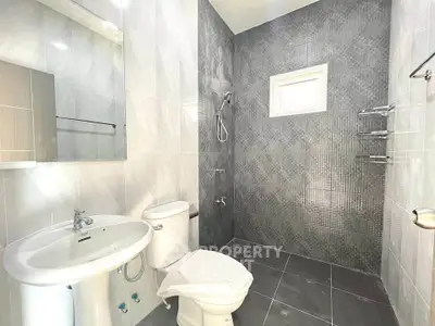 Modern bathroom with sleek gray tiles and contemporary fixtures