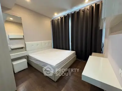 Modern bedroom with stylish furniture and elegant curtains