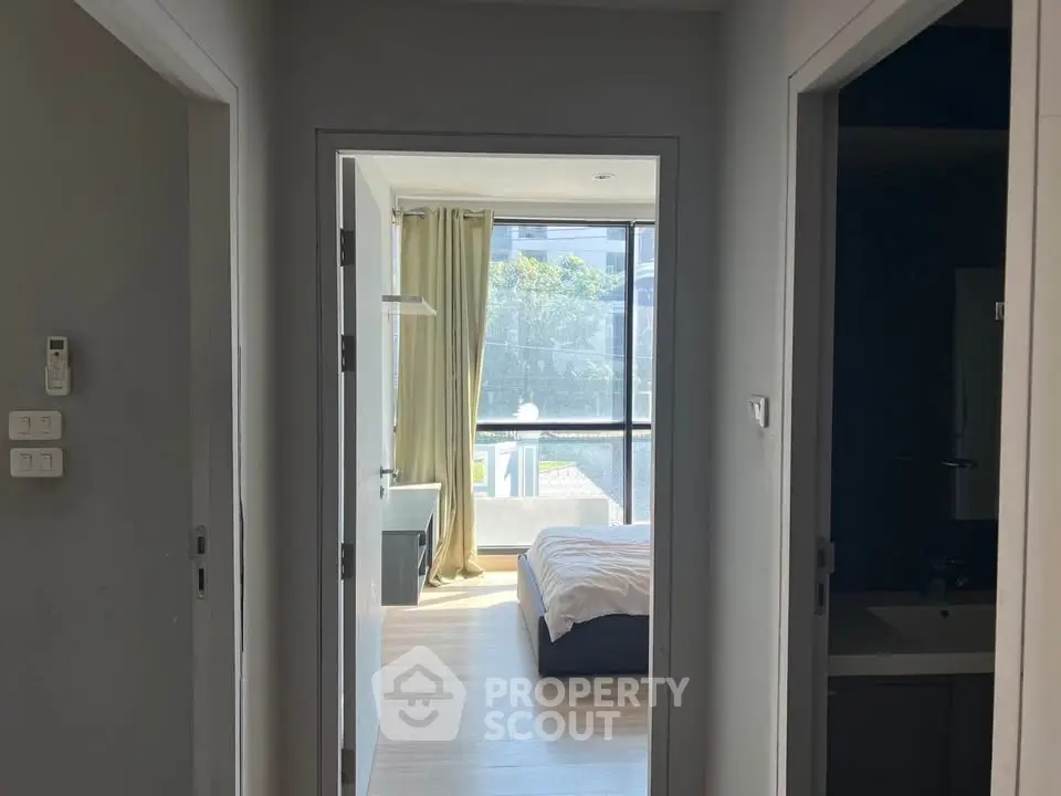 Bright bedroom with large window and modern decor in a stylish apartment.