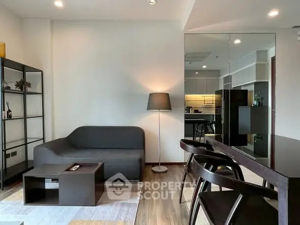 Modern living room with sleek furniture and open kitchen layout