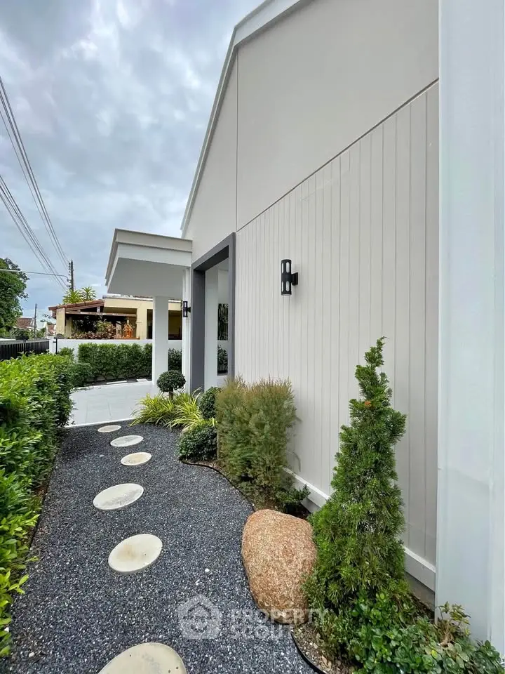 Charming modern house exterior with landscaped garden and pathway