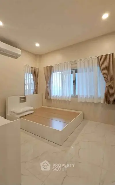 Spacious minimalist bedroom with modern design and natural light