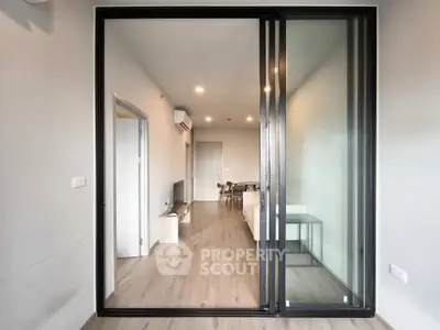 Modern living room with sliding glass doors and wooden flooring