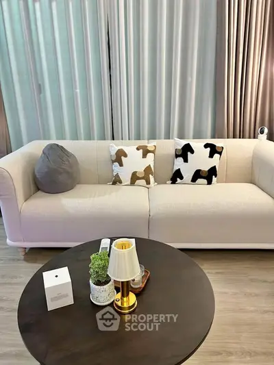 Cozy living room with elegant sofa and stylish decor, perfect for relaxation and entertaining.