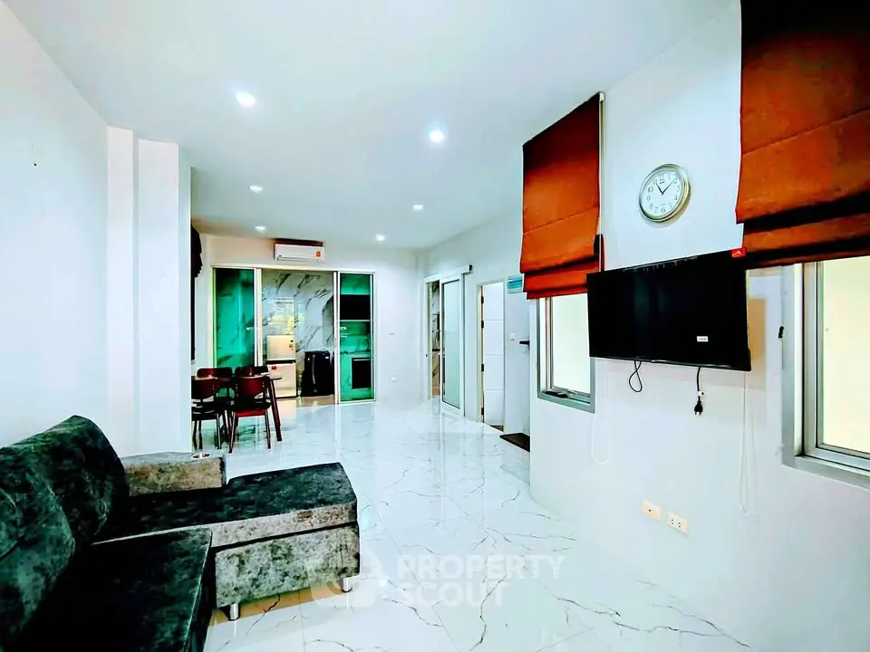 Modern living room with sleek design and open kitchen layout