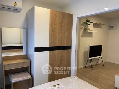 Modern bedroom with stylish wardrobe and cozy decor in a contemporary apartment.