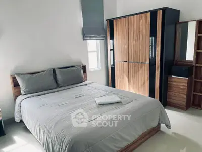 Modern bedroom with sleek wooden furniture and natural light