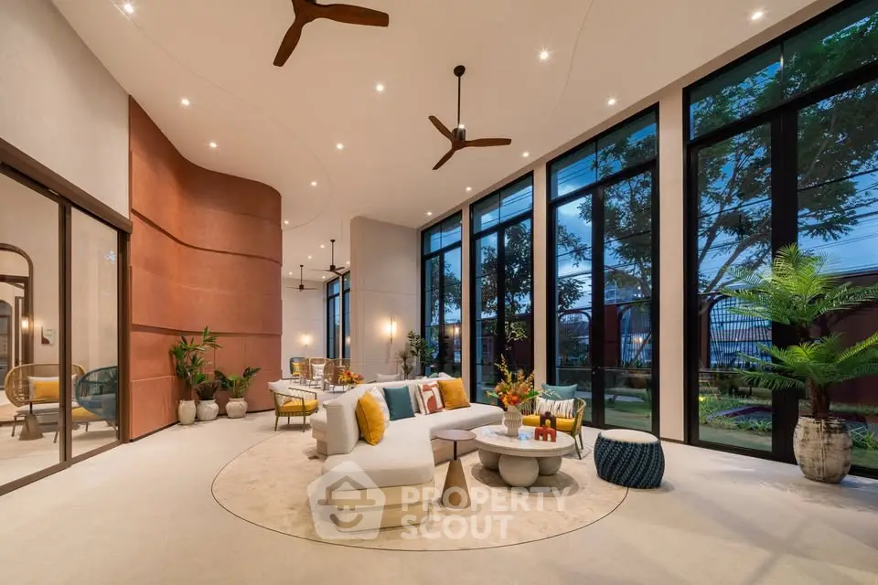 Luxurious modern living room with floor-to-ceiling windows and elegant decor