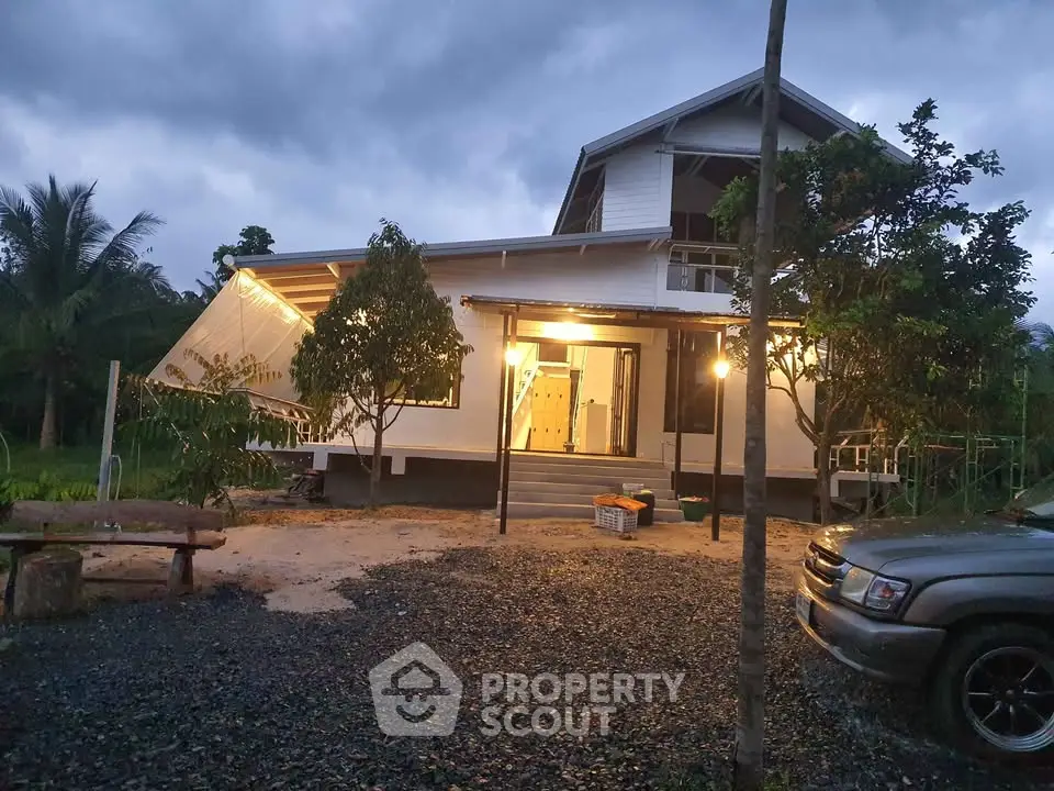 Charming modern house with unique architecture and lush greenery at dusk