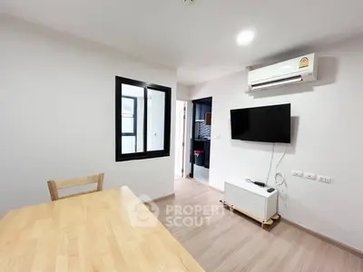 Modern living room with wall-mounted TV and air conditioning