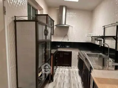 Modern kitchen with sleek cabinetry and stainless steel appliances in a compact layout.