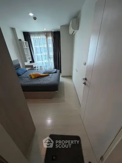 Modern bedroom with large window and stylish decor in urban apartment