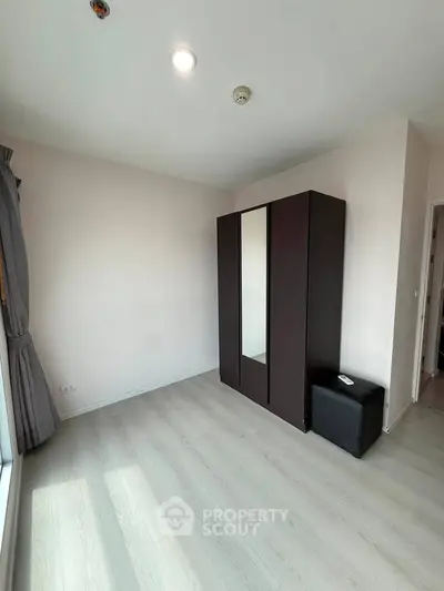 Spacious bedroom with modern wardrobe and natural light