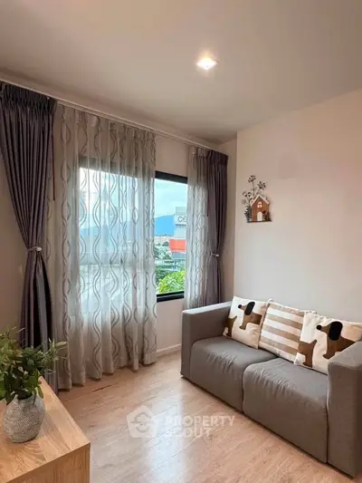 Cozy living room with stylish decor and large window view