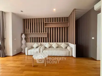 Modern living room with stylish wood paneling and elegant white sofa