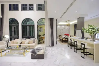 Luxurious open-plan living and dining area with elegant decor and high ceilings.