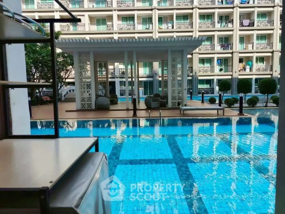 Luxurious poolside view with modern architecture and inviting lounge area.