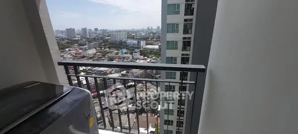 Stunning high-rise balcony view with cityscape and washing machine.