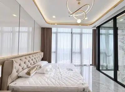 Luxurious bedroom with floor-to-ceiling windows and modern chandelier in high-rise apartment.
