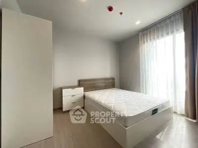 Modern minimalist bedroom with natural light and sleek furnishings
