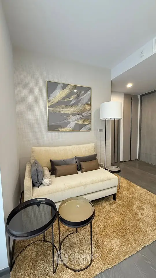 Modern living room with cozy sofa, stylish decor, and elegant lighting in a contemporary apartment.