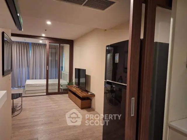 Modern apartment interior with open layout, featuring a sleek kitchen and cozy living area.