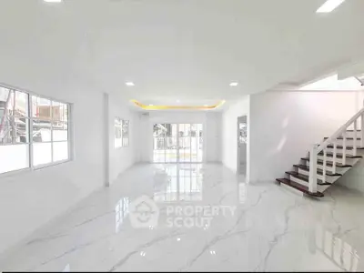 Spacious modern living room with marble flooring and staircase