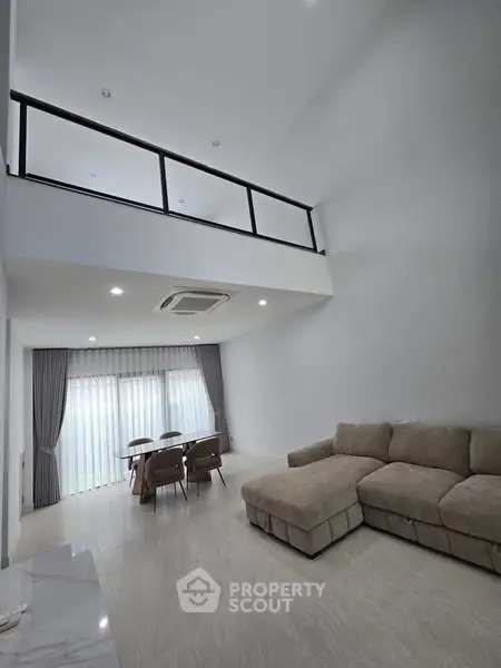 Spacious modern living room with high ceiling and elegant decor
