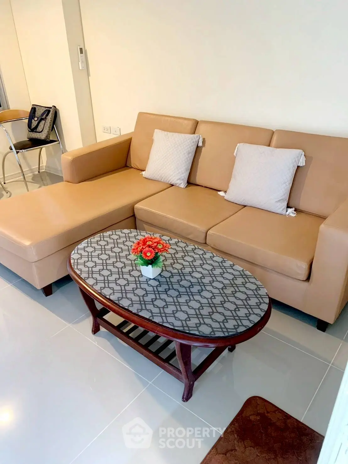 Modern living room with stylish beige sofa and elegant coffee table in cozy apartment.