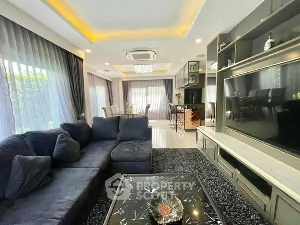 Luxurious living room with modern decor and large windows for natural light.