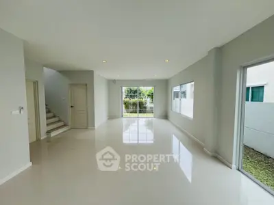 Spacious modern living room with large windows and garden view