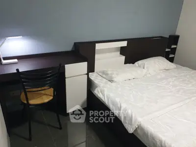 Cozy bedroom with modern desk and comfortable bed, perfect for relaxation and productivity.