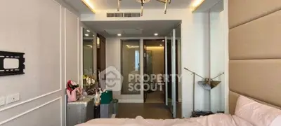 Modern bedroom with stylish decor and ensuite bathroom in a luxury apartment.