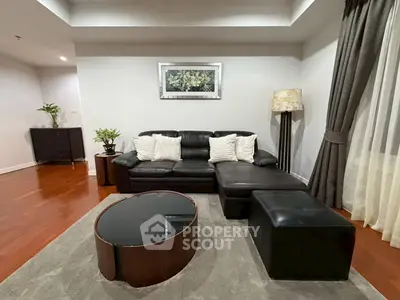Elegant living room with black leather sofa and modern decor