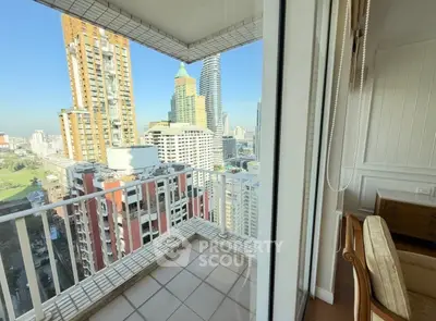 Stunning city view from a high-rise balcony with modern urban skyline.