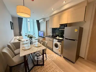 Modern open-plan living room and kitchen with dining area, featuring sleek appliances and stylish decor.